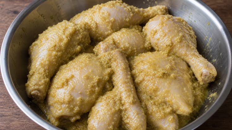 Ayam Goreng Kalasan method step 1, Grind the restrained bumbu: A pale, smooth paste coats the chicken with no visible candlenut chunks.