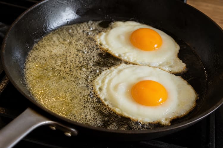 Bistro Steak & Eggs with Shallot Jus method step 5, Baste two eggs to a custardy centre: Every white is opaque and firm, edges are lightly gold, and yolks wobble as one thick mass.