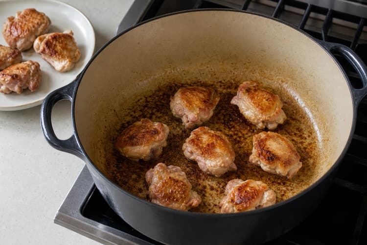 One-Pot Chicken Curry method step 2, Brown in two fast batches: Each piece has two bronze faces and the pot base carries brown fond without black patches.