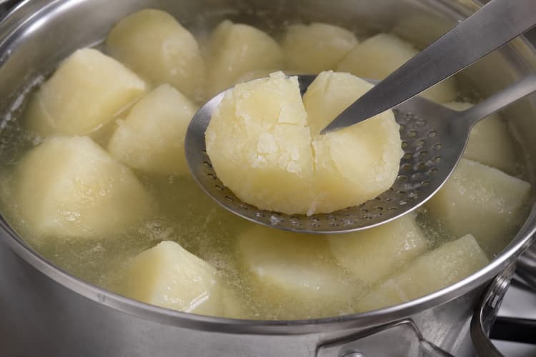Ultra-Crispy Smashed Potatoes method step 2, Alkaline-parboil the potato: A thin knife enters with slight resistance and the exterior looks softened and fissured.