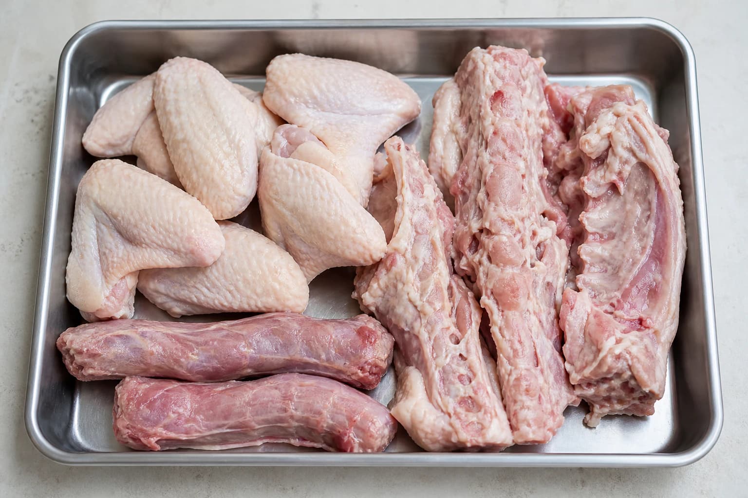chicken wings, necks, or carcasses (sayap, leher, atau kerangka ayam) for Hainanese Chicken Rice