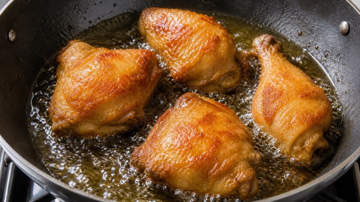 Ayam Goreng Kalasan, step 6, Briefly fry the cooked chicken: Deep-golden crisp ridges form while spice flecks remain brown, not black.