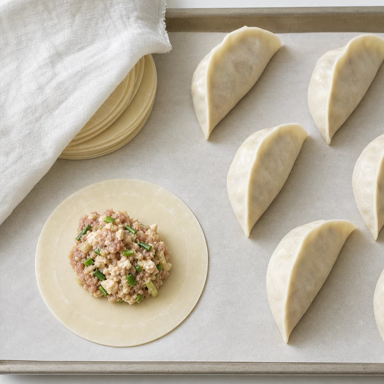 Homemade Pork Mandu, step 3, Fill and seal clean half-moons: Each mandu is plump without strain, with no air pocket, filling smear, crack, or gap along the rim.