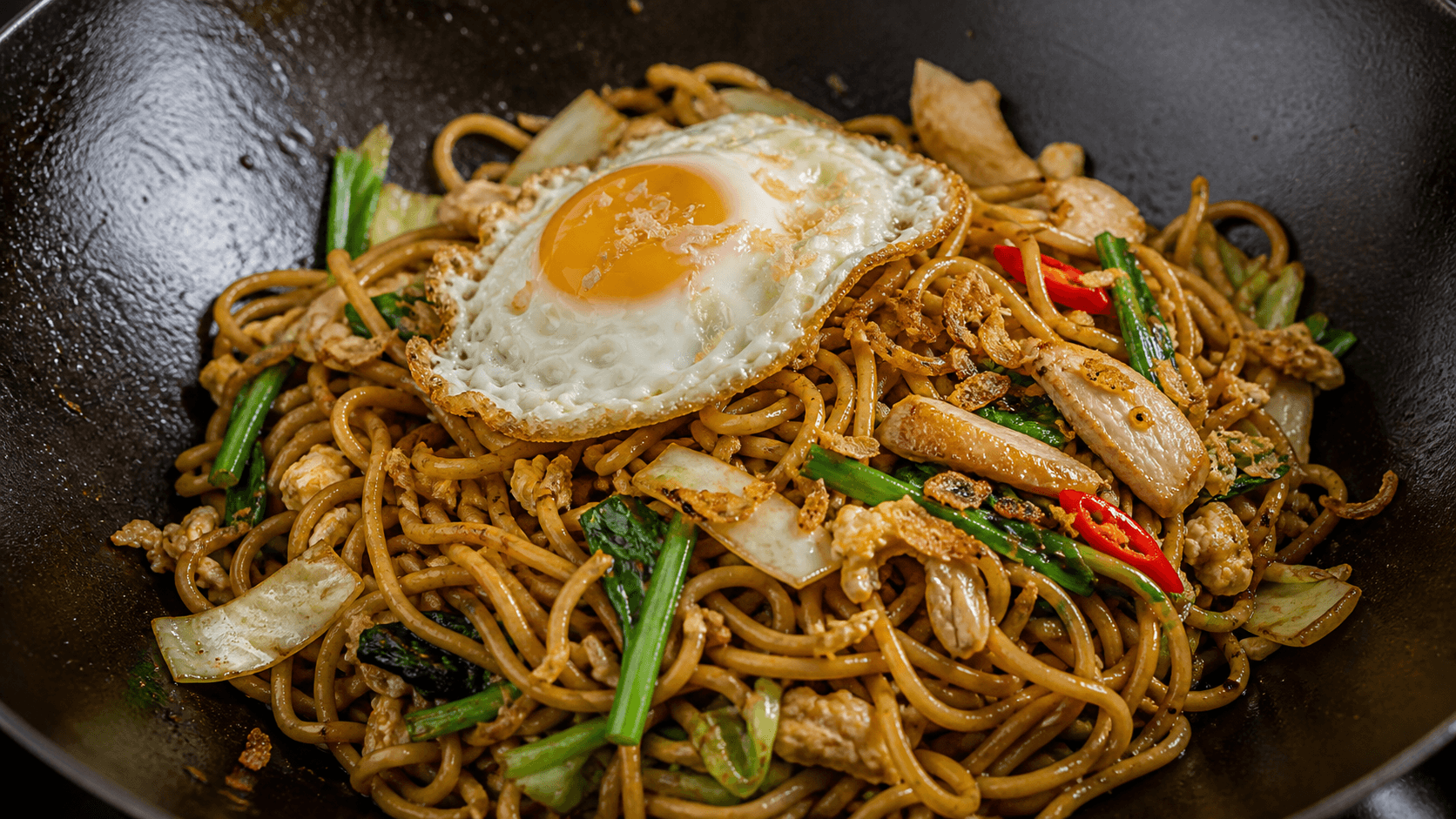 Mie Goreng, step 5, Finish with egg or protein: Glossy noodles that still bounce.