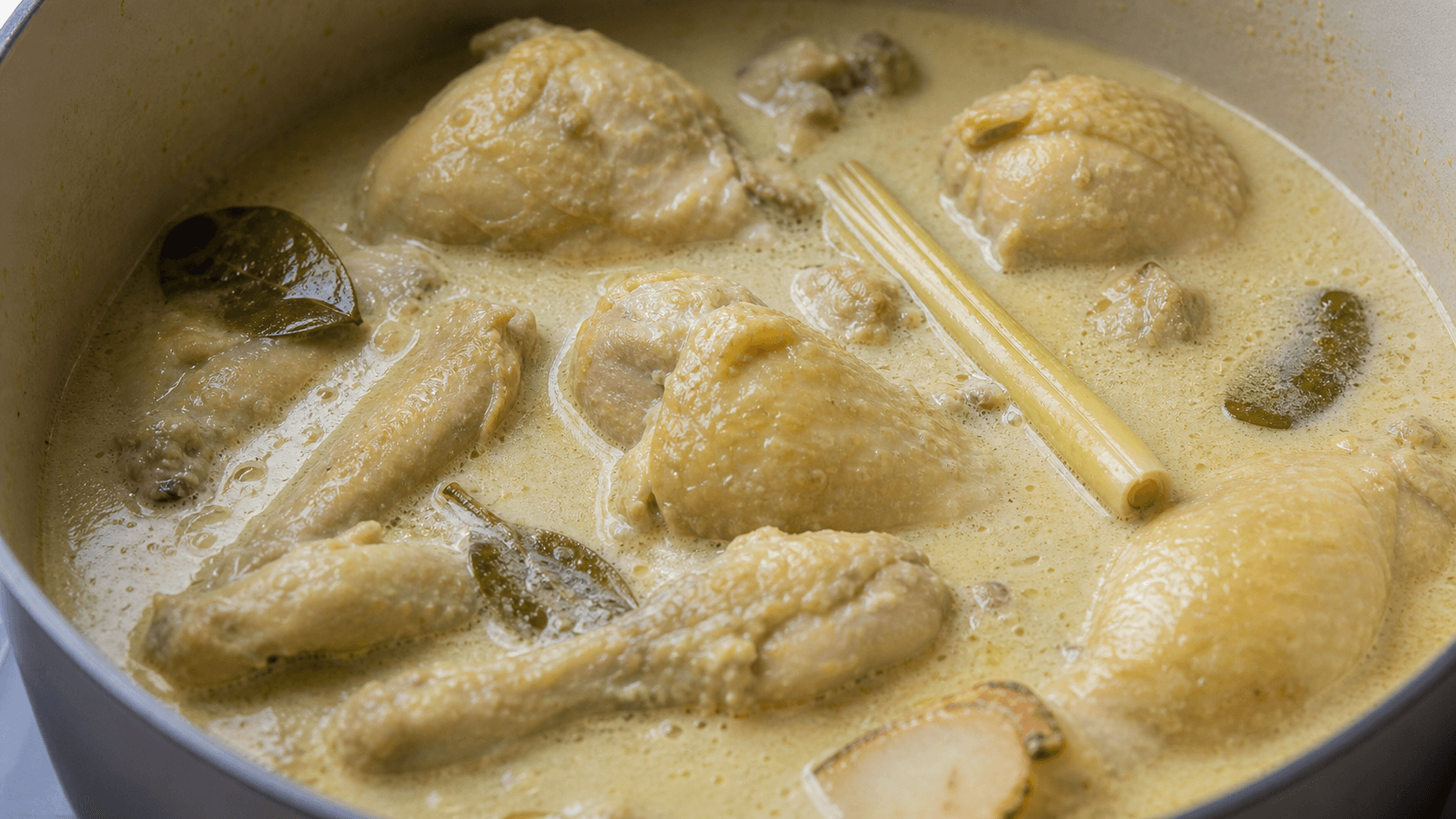 Opor Ayam, step 3, Braise chicken gently: Small bubbles and creamy yellow sauce.