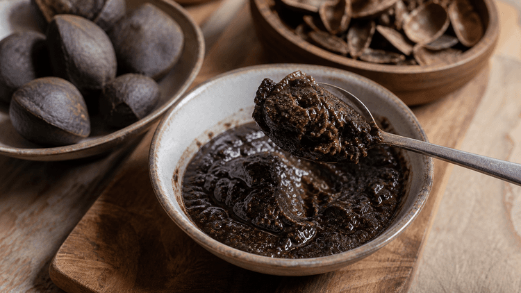 Rawon method step 1, Prepare safe keluak: Dark paste that smells earthy and nutty.