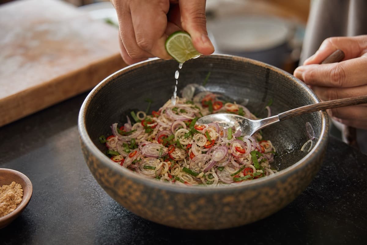 Crispy-Skin Salmon Sambal Matah, step 4, Add lime only after the heat subsides: The relish smells first of lemongrass and lime leaf and tastes bright rather than oily.