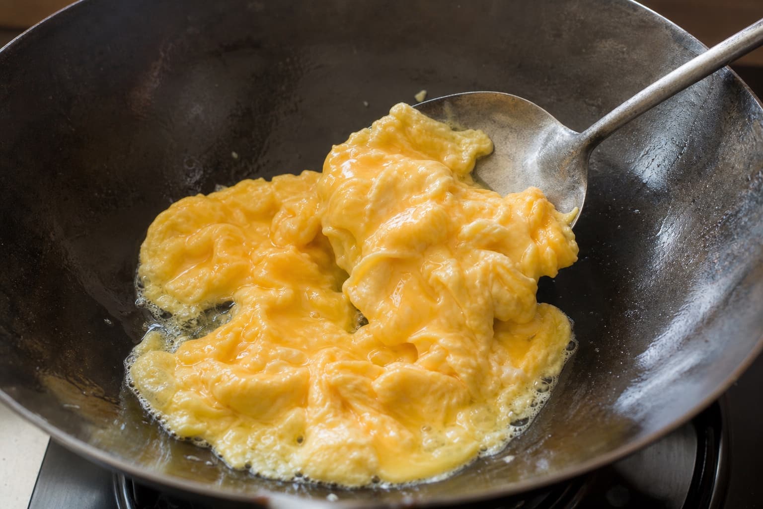 Tomato Egg Stir-Fry, step 3, Soft-scramble and lift early: Large puffy curds remain glossy and moist on top with no brown crust.